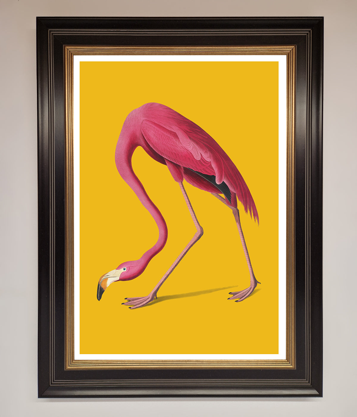 Pink Flamingo on Yellow Framed Print with elegant black frame.