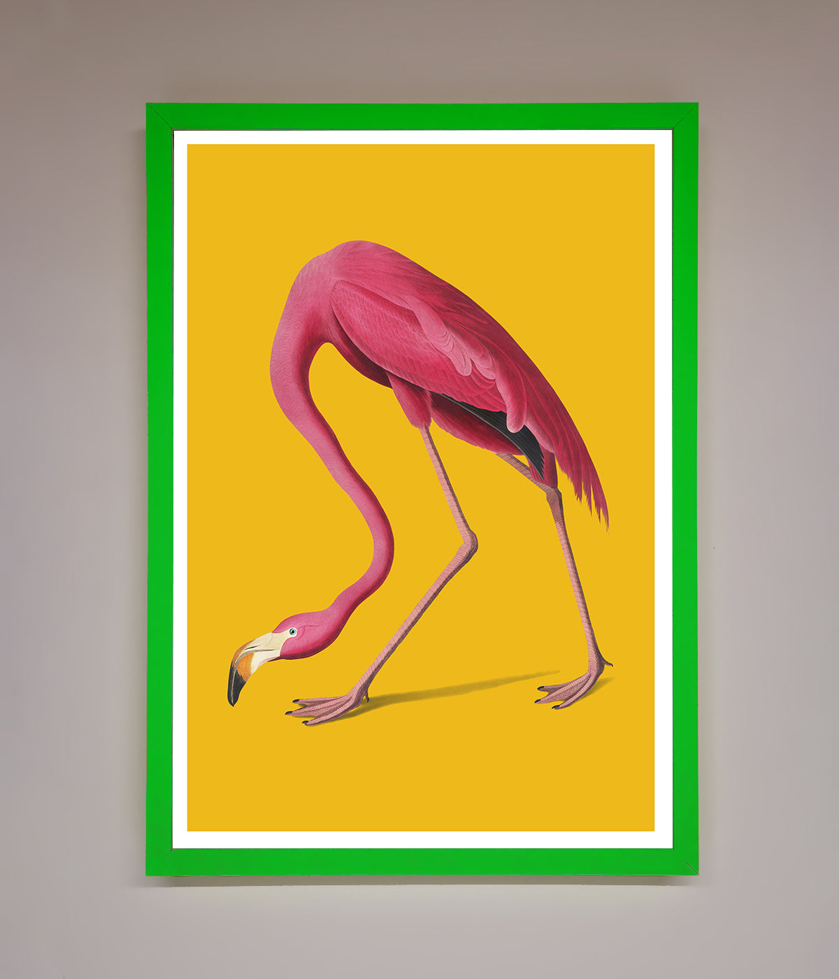 Pink flamingo on yellow background framed print.