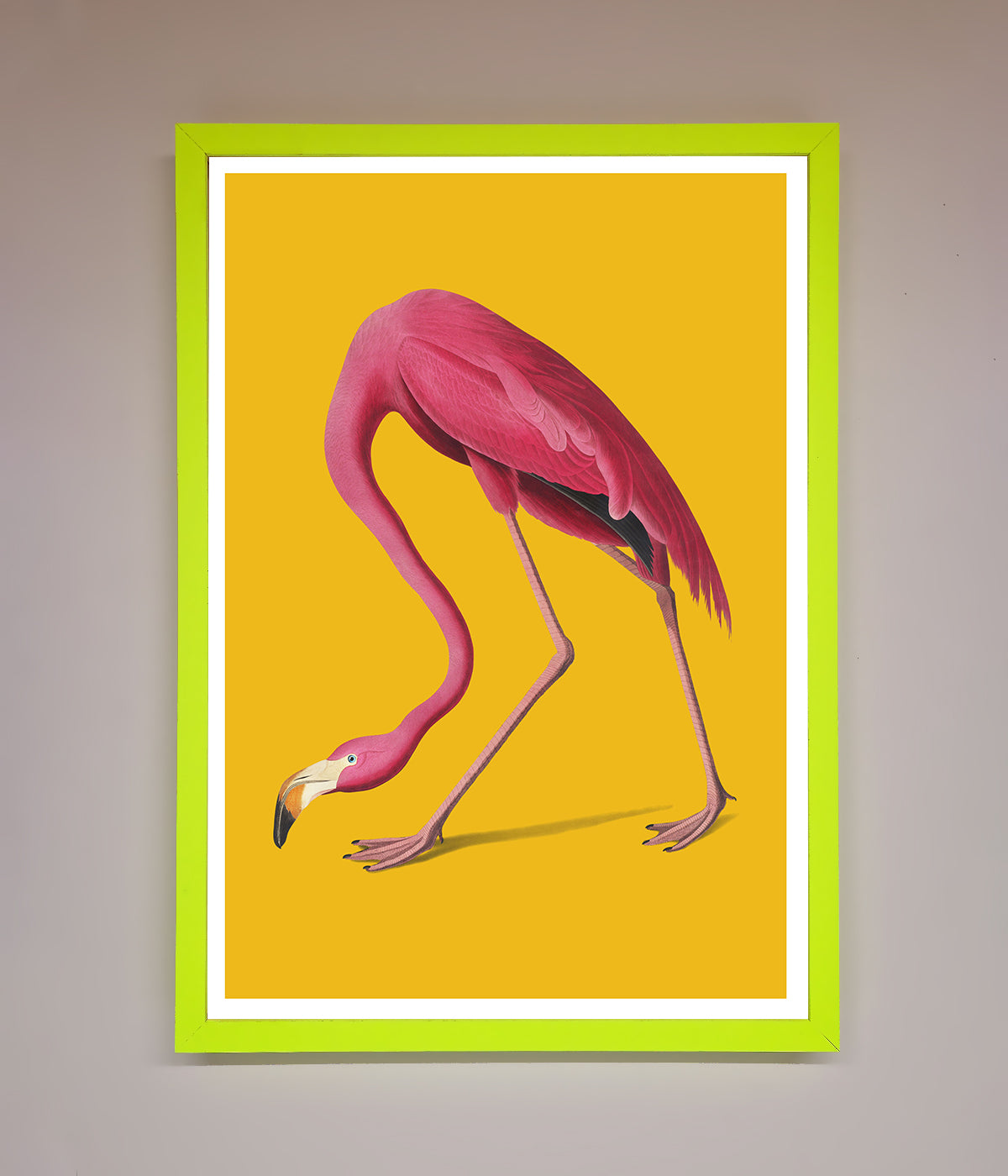 Pink flamingo on yellow framed print adding colorful decor.