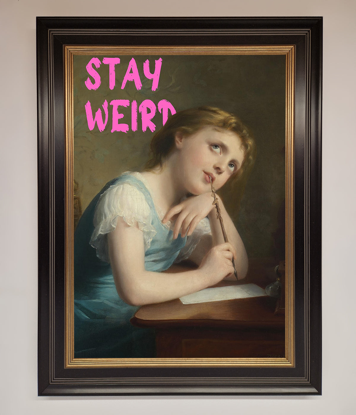 Framed print titled "Stay Weird" with a vintage portrait of a thoughtful woman.