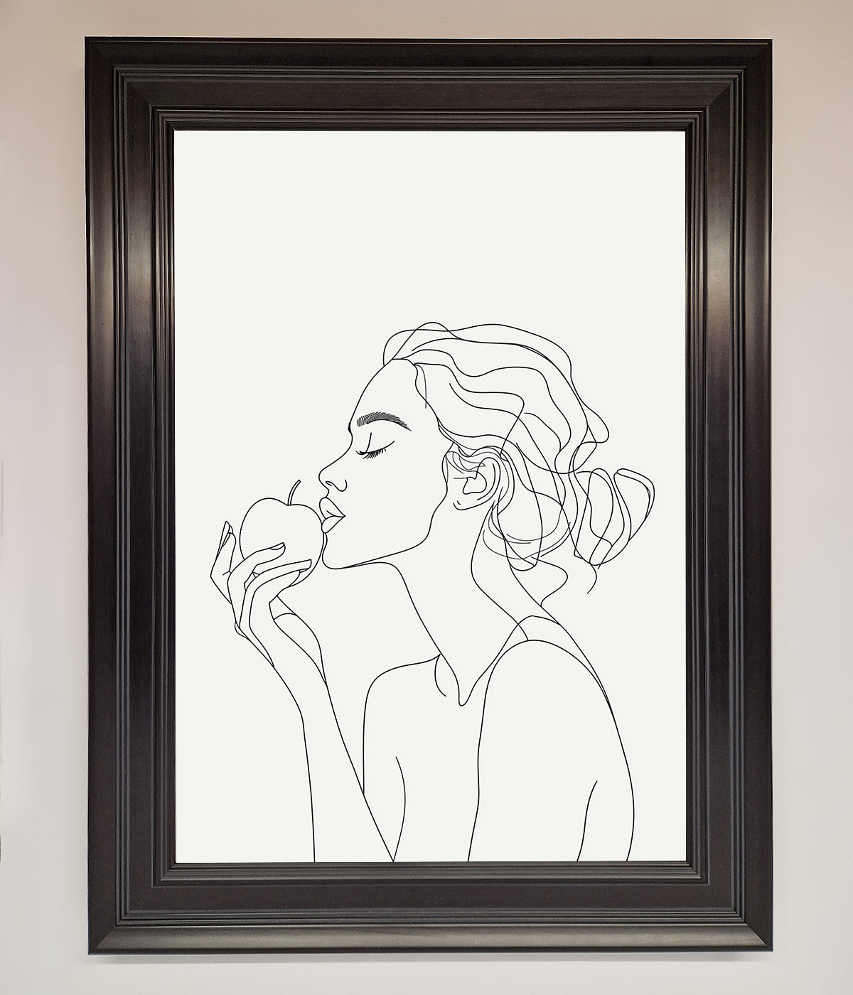 Line drawing of a woman holding an apple in a black frame poster.